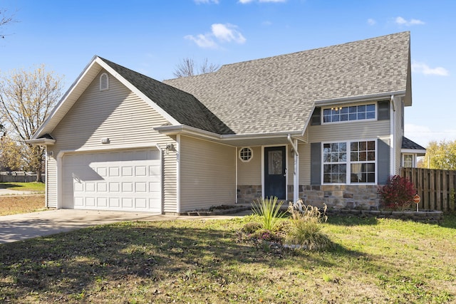 view of front of property with a front yard and a garage