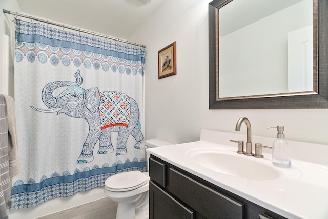 bathroom with vanity, toilet, and a shower with shower curtain