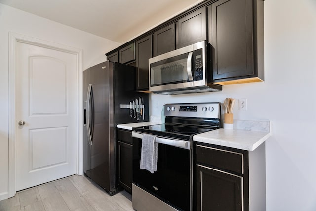 kitchen featuring light hardwood / wood-style flooring and appliances with stainless steel finishes