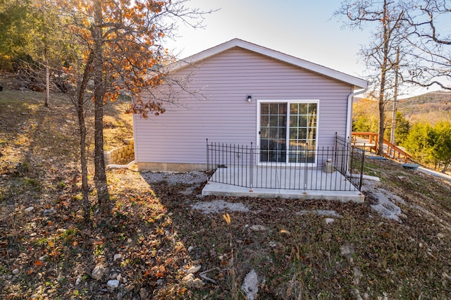 back of property featuring a wooden deck