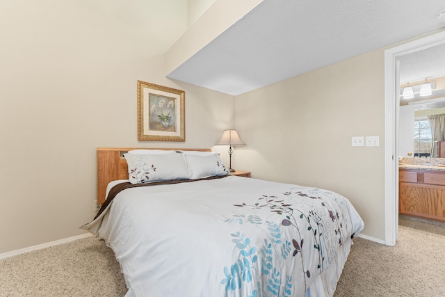 carpeted bedroom featuring ensuite bath