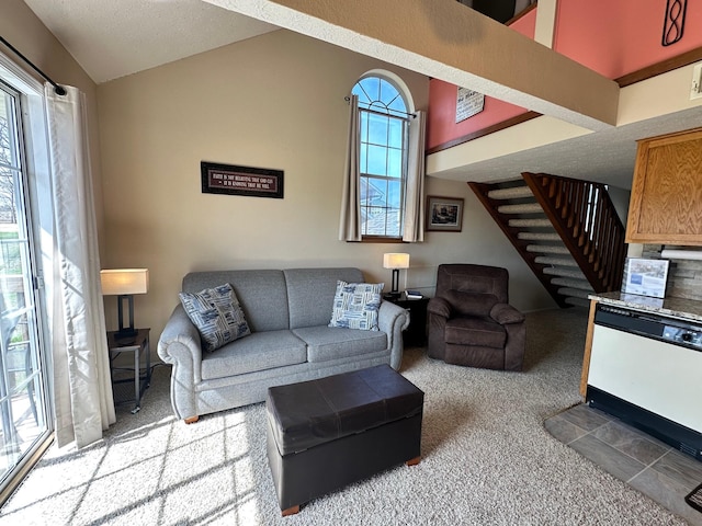 carpeted living room featuring a textured ceiling, plenty of natural light, and lofted ceiling