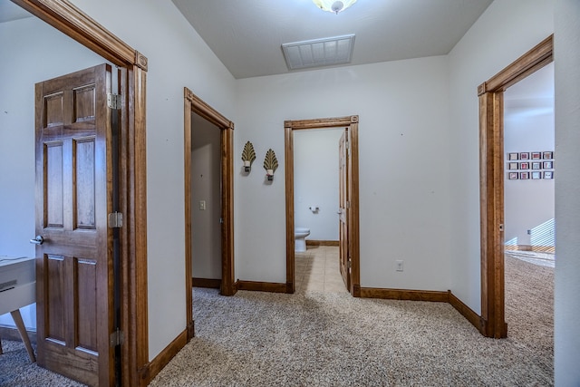 hall with light colored carpet