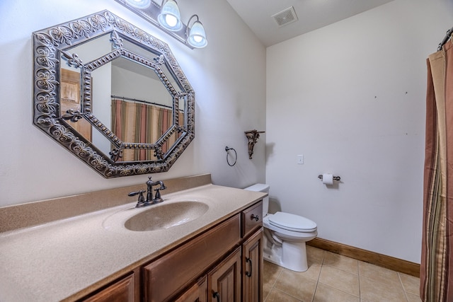 bathroom featuring tile patterned floors, vanity, and toilet