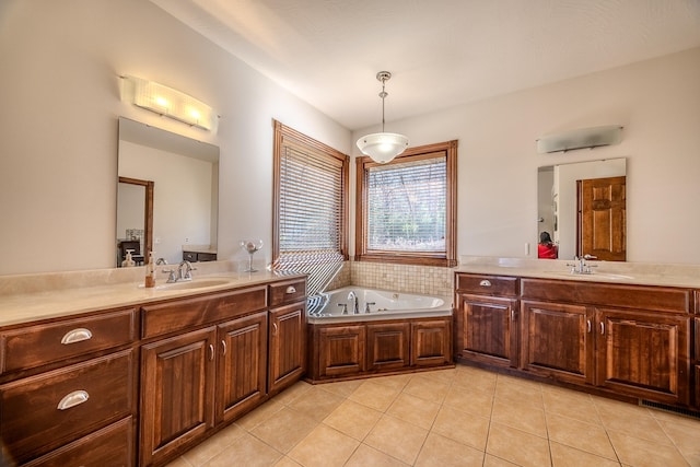 bathroom with tile patterned flooring, vanity, and a bath