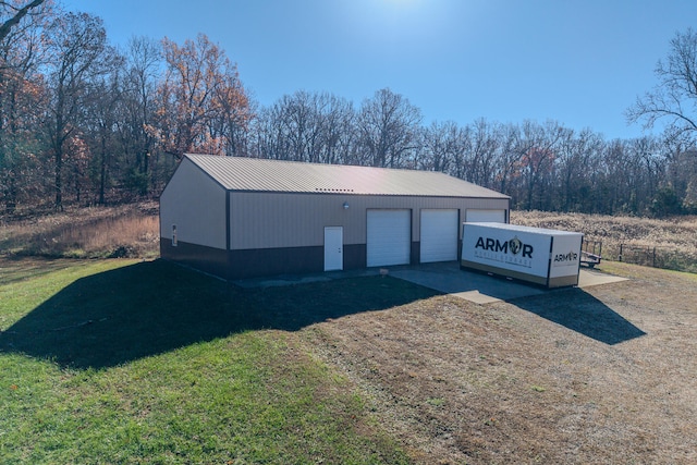 view of outdoor structure with a yard and a garage