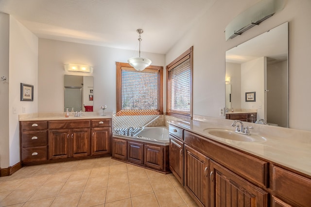 bathroom featuring tile patterned floors, a bathing tub, and vanity