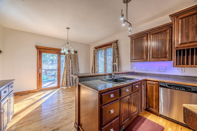 kitchen featuring dishwasher, sink, a healthy amount of sunlight, and light hardwood / wood-style flooring