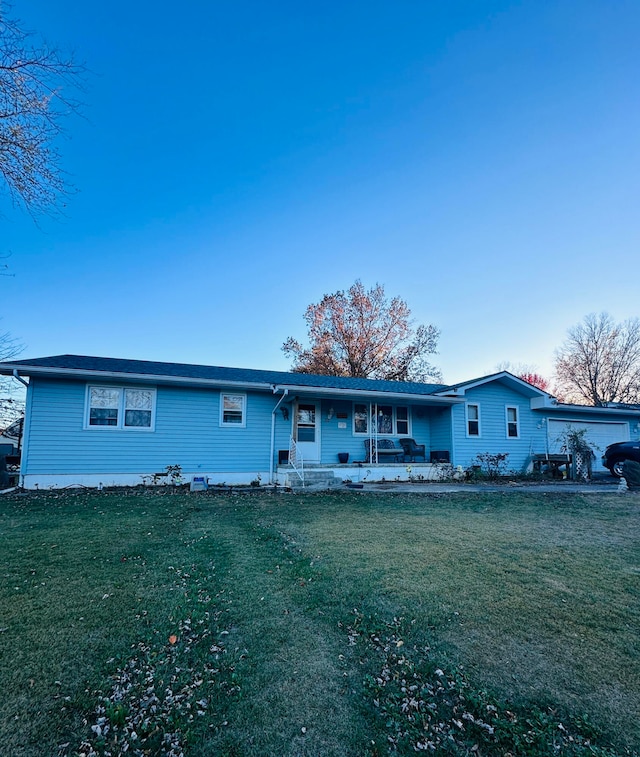 ranch-style home with covered porch and a front yard