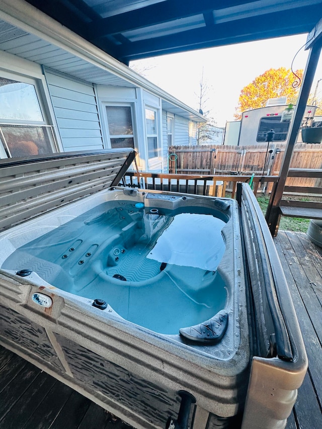 wooden terrace featuring a hot tub