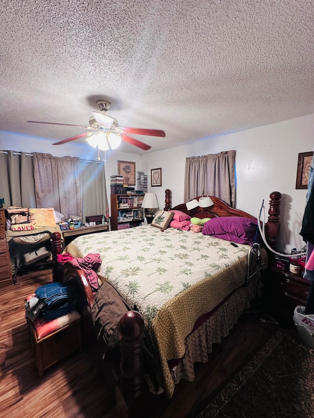 bedroom with hardwood / wood-style floors, ceiling fan, and a textured ceiling