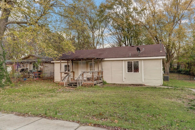 view of front of property featuring a deck, a front yard, and fence