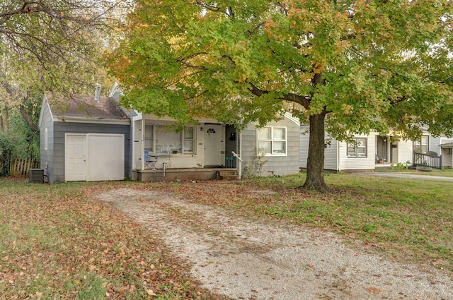 obstructed view of property featuring covered porch and a front lawn