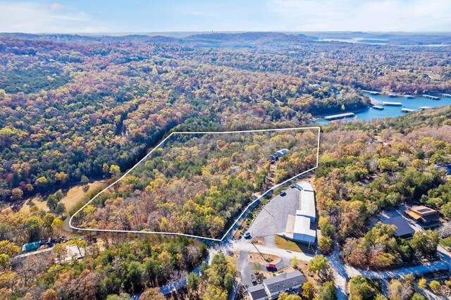 aerial view with a wooded view and a water view