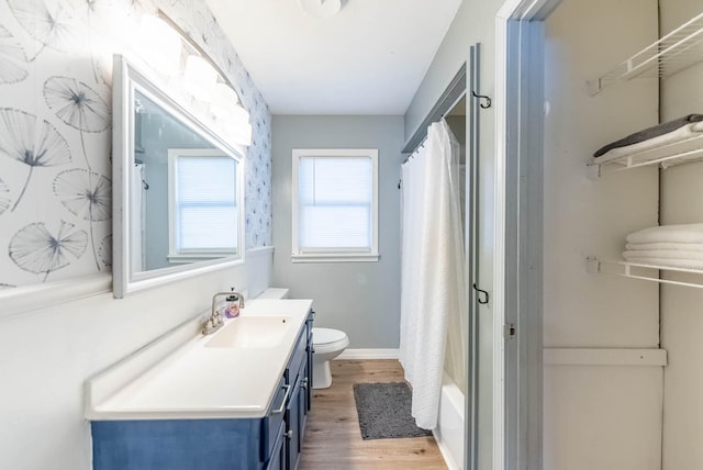 full bathroom with wood-type flooring, vanity, toilet, and shower / bath combination with curtain