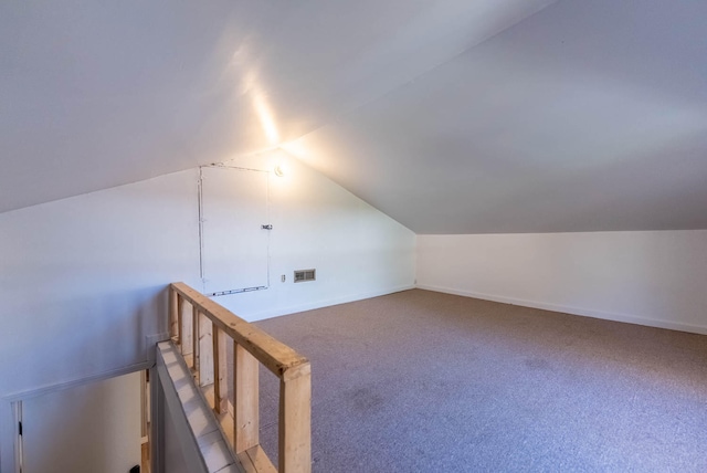 additional living space featuring carpet and lofted ceiling