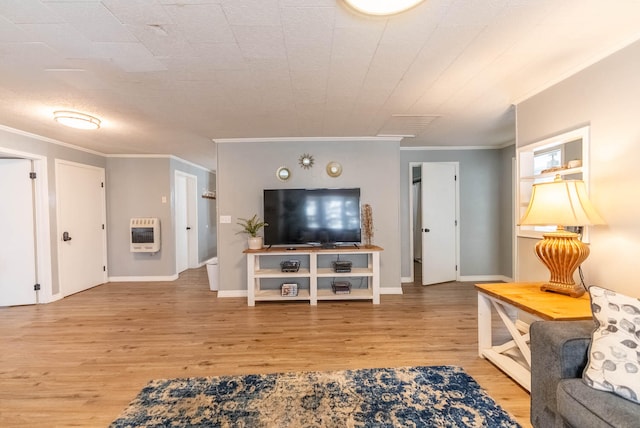 living room featuring hardwood / wood-style floors, ornamental molding, and heating unit