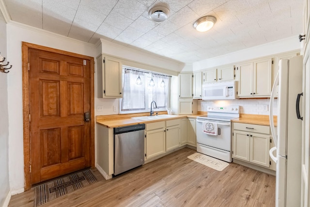 kitchen featuring white appliances, crown molding, sink, butcher block countertops, and light hardwood / wood-style floors