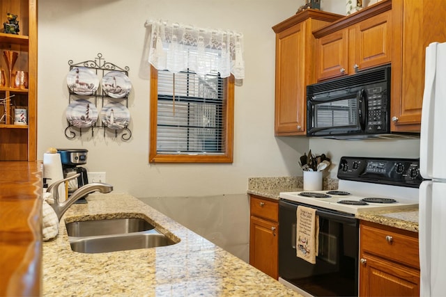 kitchen featuring light stone counters, sink, and white appliances