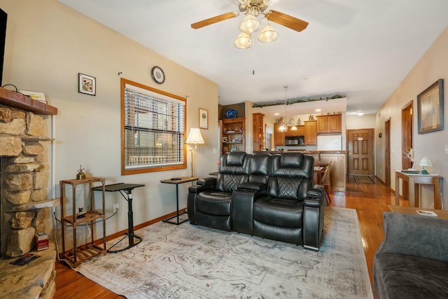 living room featuring ceiling fan and light hardwood / wood-style floors