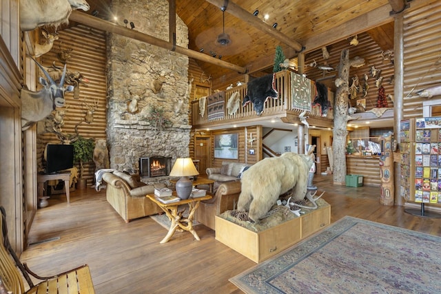 living room featuring a fireplace, hardwood / wood-style flooring, high vaulted ceiling, and wood ceiling