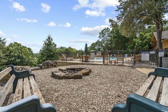 view of yard with a fire pit, a patio area, and a community pool