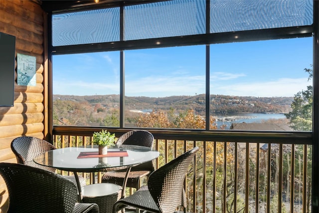 unfurnished sunroom with a water view