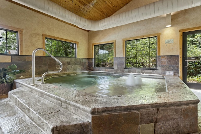 interior space with an indoor in ground hot tub