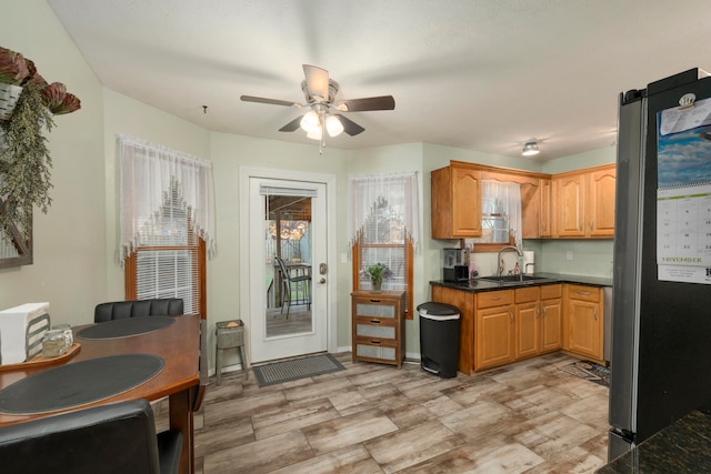 kitchen with stainless steel fridge, ceiling fan, and sink