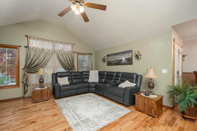 living room with ceiling fan, light wood-type flooring, and vaulted ceiling