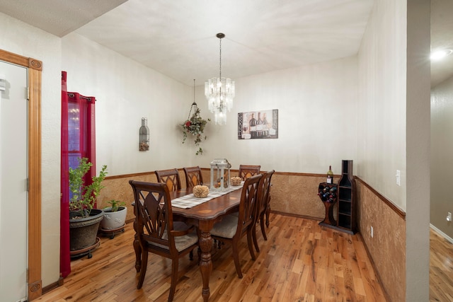 dining room featuring a notable chandelier and wood-type flooring