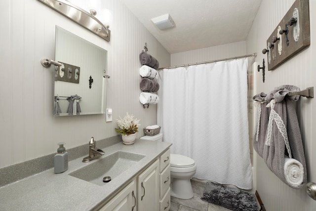 full bathroom with tile patterned flooring, vanity, toilet, and shower / tub combo