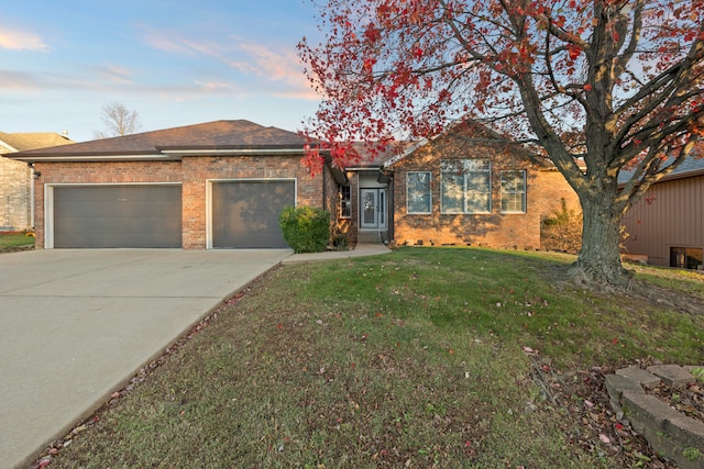 single story home with a lawn and a garage