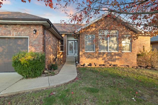 view of front facade with a lawn and a garage