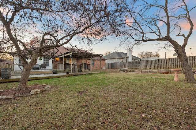 yard at dusk with a wooden deck