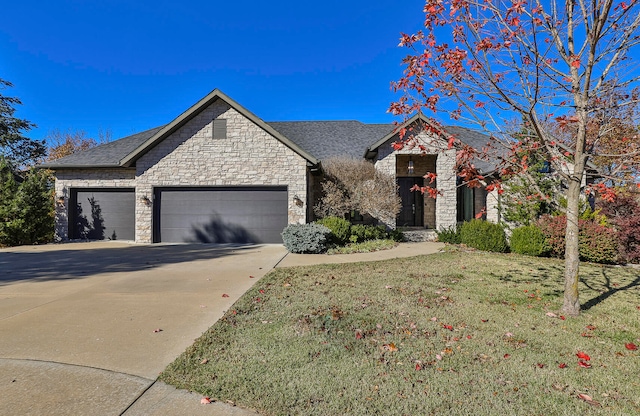 view of front of home with a front lawn and a garage