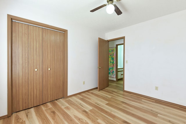 unfurnished bedroom with light wood-type flooring, a closet, and ceiling fan