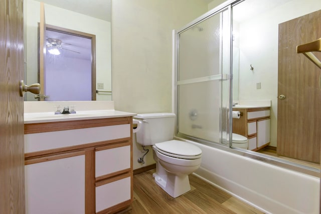 full bathroom with hardwood / wood-style flooring, ceiling fan, toilet, and enclosed tub / shower combo