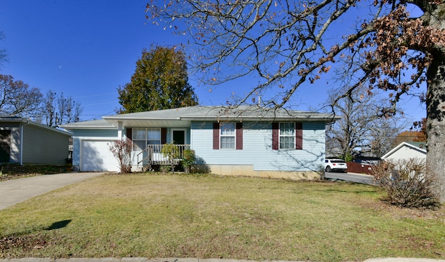 view of front of home featuring a garage, covered porch, and a front yard