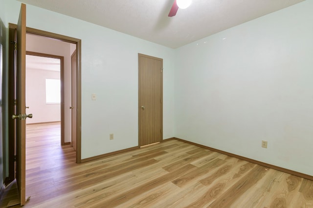 unfurnished bedroom featuring light hardwood / wood-style floors and ceiling fan