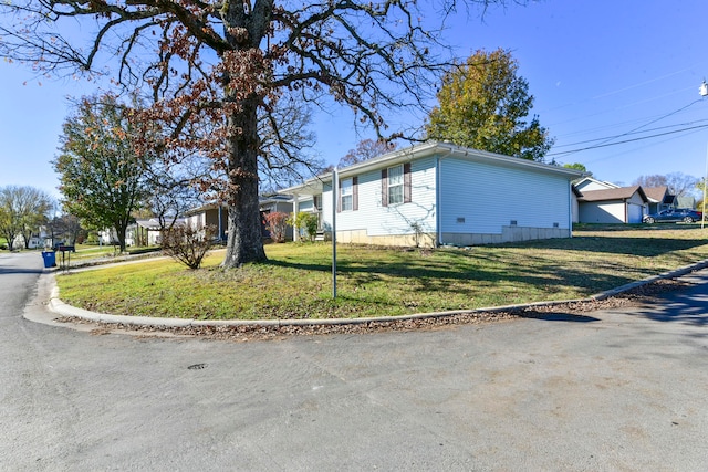 view of side of home featuring a yard