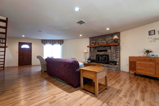 living room with light hardwood / wood-style floors and a fireplace