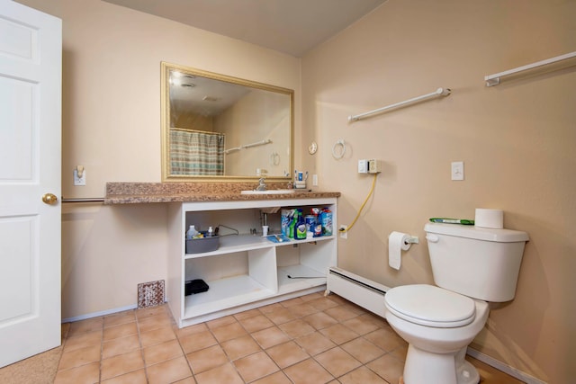 bathroom featuring tile patterned floors, toilet, and a baseboard heating unit