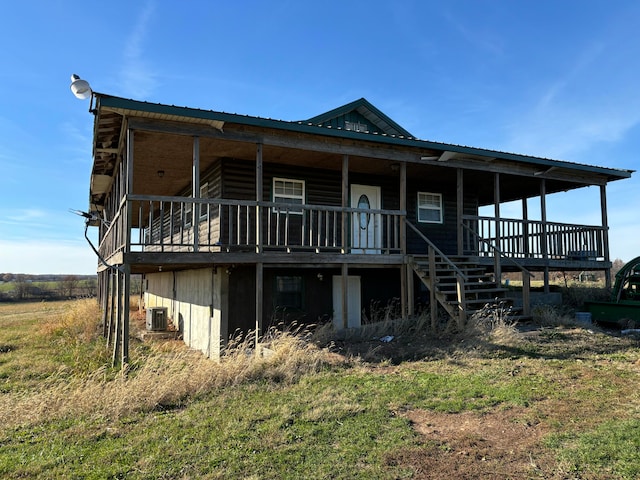 back of property featuring a wooden deck and central AC