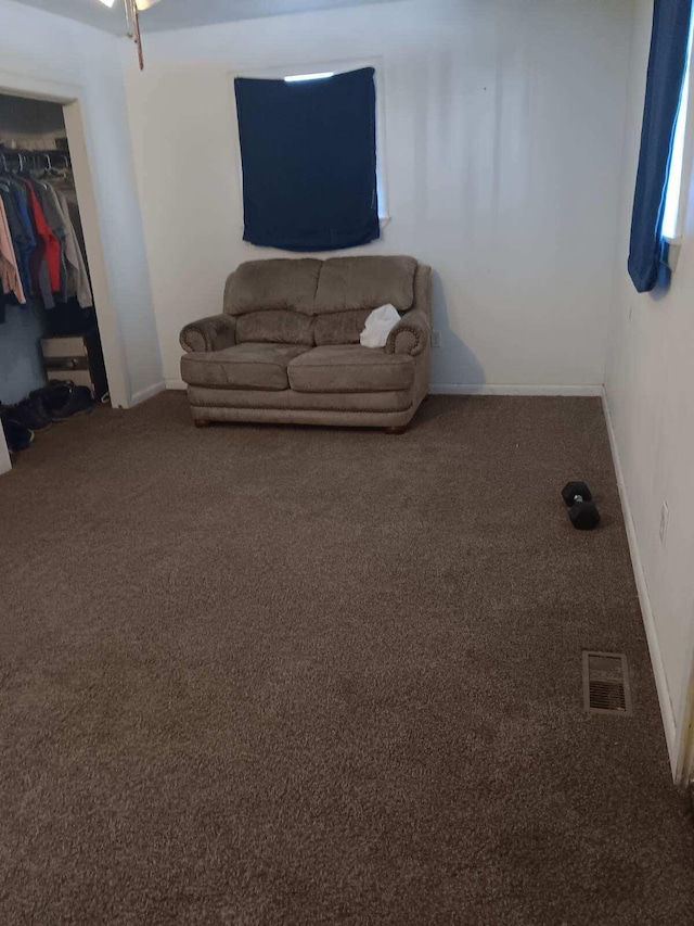 sitting room featuring carpet floors, baseboards, and visible vents