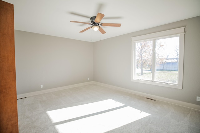 empty room with light carpet and ceiling fan