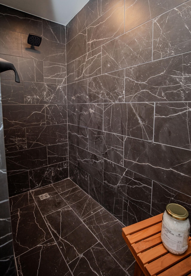 bathroom with tile walls and tiled shower