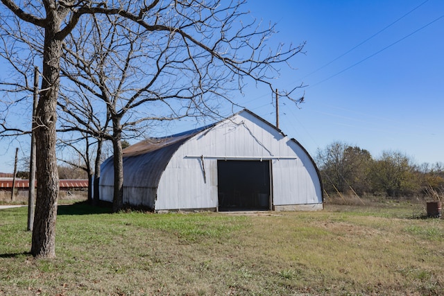 view of outbuilding with a lawn