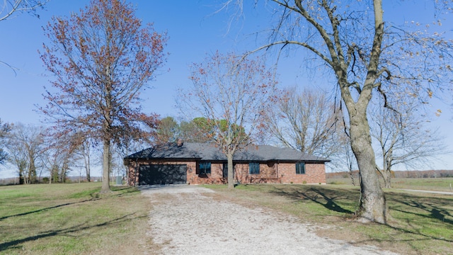 ranch-style home with a front lawn and a garage