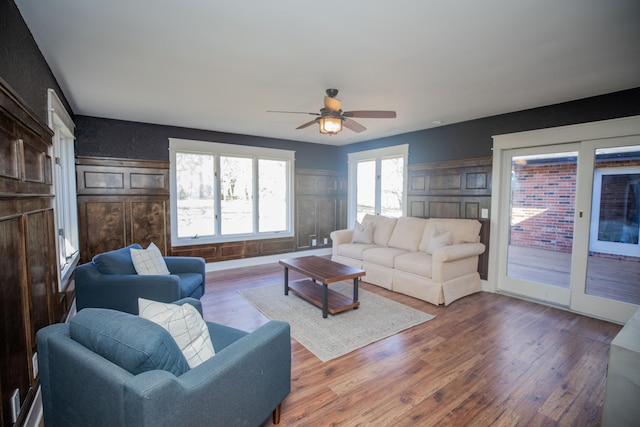 living room featuring wood-type flooring and ceiling fan